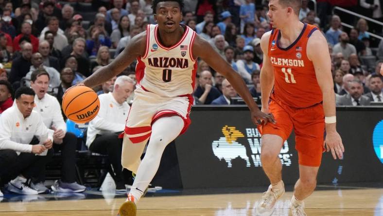 Mar 28, 2024; Los Angeles, CA, USA; Arizona Wildcats guard Jaden Bradley (0) controls the ball against Clemson Tigers guard Joseph Girard III (11) in the first half in the semifinals of the West Regional of the 2024 NCAA Tournament at Crypto.com Arena. Mandatory Credit: Kirby Lee-USA TODAY Sports