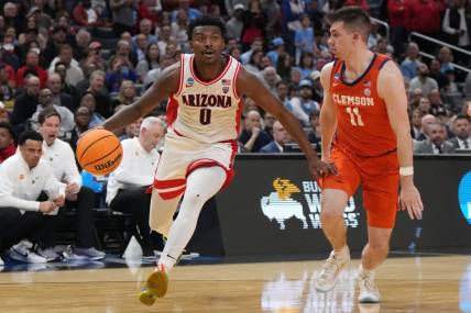 Mar 28, 2024; Los Angeles, CA, USA; Arizona Wildcats guard Jaden Bradley (0) controls the ball against Clemson Tigers guard Joseph Girard III (11) in the first half in the semifinals of the West Regional of the 2024 NCAA Tournament at Crypto.com Arena. Mandatory Credit: Kirby Lee-USA TODAY Sports