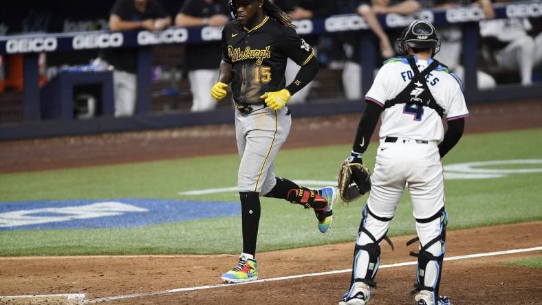 Mar 28, 2024; Miami, Florida, USA;  Pittsburgh Pirates shortstop Oneil Cruz (15) trots to home plate in front of Miami Marlins catcher Nick Fortes (4) during the eighth inning, at loanDepot Park. Mandatory Credit: Michael Laughlin-USA TODAY Sports