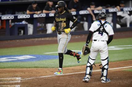 Mar 28, 2024; Miami, Florida, USA;  Pittsburgh Pirates shortstop Oneil Cruz (15) trots to home plate in front of Miami Marlins catcher Nick Fortes (4) during the eighth inning, at loanDepot Park. Mandatory Credit: Michael Laughlin-USA TODAY Sports