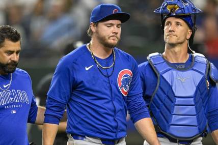 Mar 31, 2024; Arlington, Texas, USA; Chicago Cubs starting pitcher Justin Steele (35) and catcher Yan Gomes (15) walk off the field after Steele suffers an injury during the fifth inning against the Texas Rangers at Globe Life Field. Mandatory Credit: Jerome Miron-USA TODAY Sports