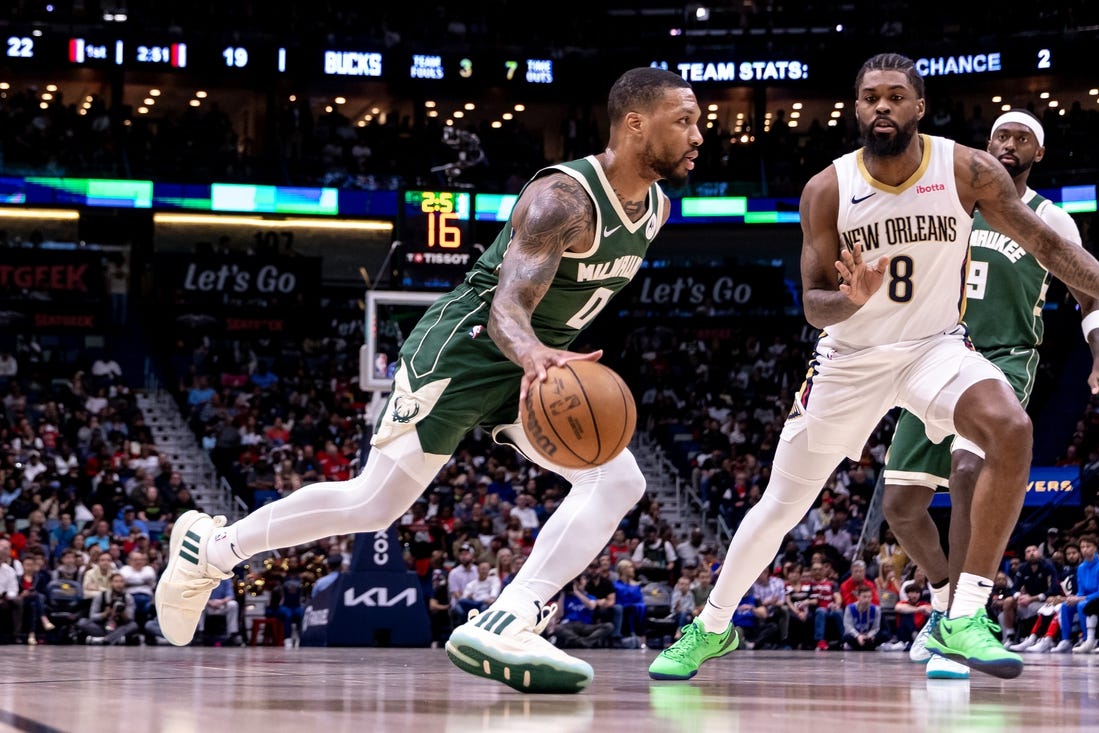 Mar 28, 2024; New Orleans, Louisiana, USA;  Milwaukee Bucks guard Damian Lillard (0) dribbles against New Orleans Pelicans forward Naji Marshall (8) during the first half at Smoothie King Center. Mandatory Credit: Stephen Lew-USA TODAY Sports