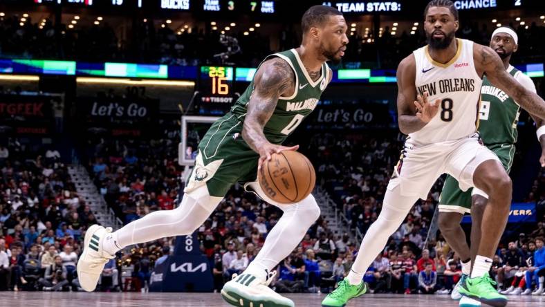 Mar 28, 2024; New Orleans, Louisiana, USA;  Milwaukee Bucks guard Damian Lillard (0) dribbles against New Orleans Pelicans forward Naji Marshall (8) during the first half at Smoothie King Center. Mandatory Credit: Stephen Lew-USA TODAY Sports