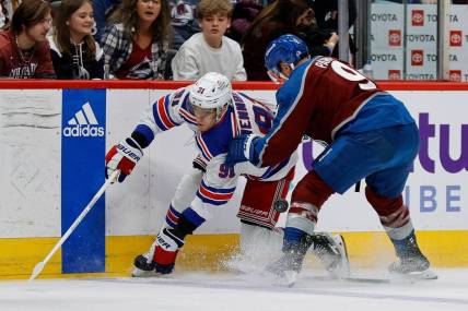 Mar 28, 2024; Denver, Colorado, USA; New York Rangers center Alex Wennberg (91) and Colorado Avalanche left wing Zach Parise (9) battle for the puck in the first period at Ball Arena. Mandatory Credit: Isaiah J. Downing-USA TODAY Sports