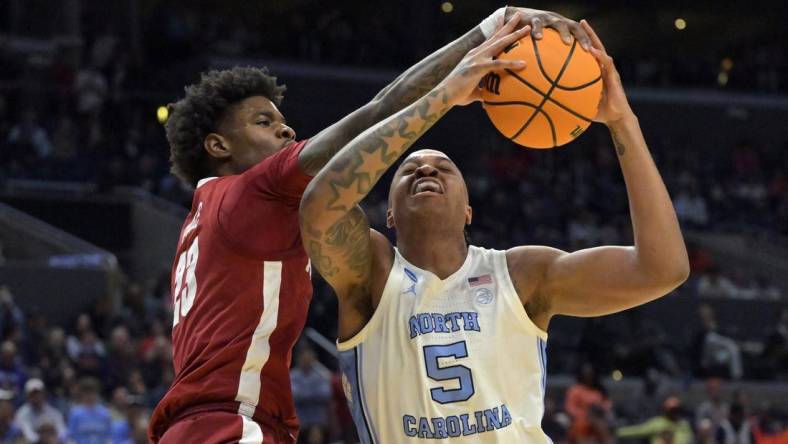 Mar 28, 2024; Los Angeles, CA, USA; Alabama Crimson Tide forward Nick Pringle (23) defends against North Carolina Tar Heels forward Armando Bacot (5) in the first half in the semifinals of the West Regional of the 2024 NCAA Tournament at Crypto.com Arena. Mandatory Credit: Jayne Kamin-Oncea-USA TODAY Sports