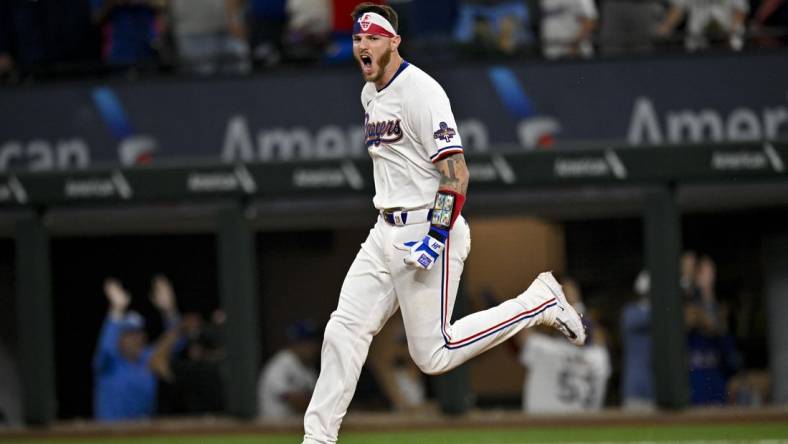 Mar 28, 2024; Arlington, Texas, USA; Texas Rangers catcher Jonah Heim (28) celebrates after he hits a walk off single against the Chicago Cubs during the tenth inning at Globe Life Field. Mandatory Credit: Jerome Miron-USA TODAY Sports