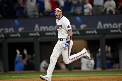 Mar 28, 2024; Arlington, Texas, USA; Texas Rangers catcher Jonah Heim (28) celebrates after he hits a walk off single against the Chicago Cubs during the tenth inning at Globe Life Field. Mandatory Credit: Jerome Miron-USA TODAY Sports