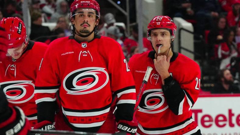 Mar 28, 2024; Raleigh, North Carolina, USA;  Carolina Hurricanes center Sebastian Aho (20) and center Seth Jarvis (24) look on against the Detroit Red Wings during the second period at PNC Arena. Mandatory Credit: James Guillory-USA TODAY Sports