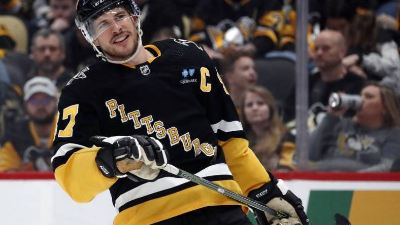 Mar 28, 2024; Pittsburgh, Pennsylvania, USA;  Pittsburgh Penguins center Sidney Crosby (87) reacts on the ice against the Columbus Blue Jackets during the third period at PPG Paints Arena. The Penguins won 3-2. Mandatory Credit: Charles LeClaire-USA TODAY Sports