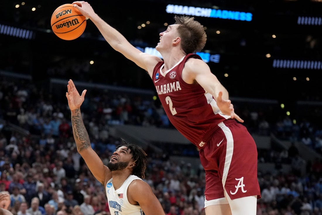 Mar 28, 2024; Los Angeles, CA, USA; Alabama Crimson Tide forward Grant Nelson (2) blocks North Carolina Tar Heels guard RJ Davis (4) in the second half in the semifinals of the West Regional of the 2024 NCAA Tournament at Crypto.com Arena. Mandatory Credit: Kirby Lee-USA TODAY Sports