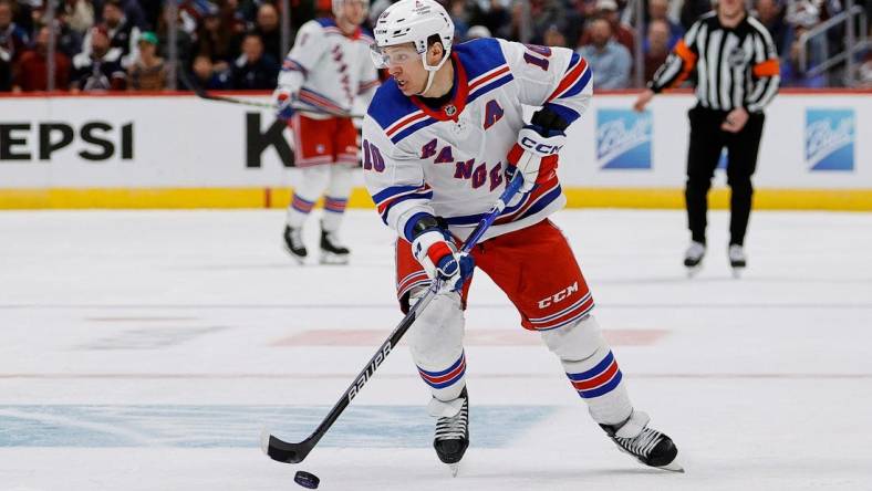 Mar 28, 2024; Denver, Colorado, USA; New York Rangers left wing Artemi Panarin (10) controls the puck in the third period against the Colorado Avalanche at Ball Arena. Mandatory Credit: Isaiah J. Downing-USA TODAY Sports