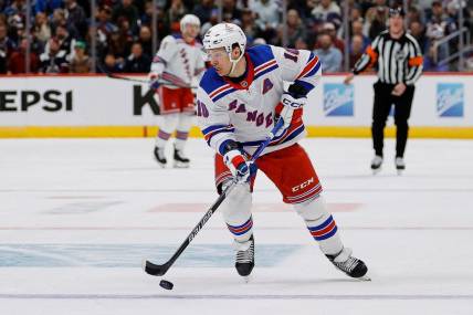 Mar 28, 2024; Denver, Colorado, USA; New York Rangers left wing Artemi Panarin (10) controls the puck in the third period against the Colorado Avalanche at Ball Arena. Mandatory Credit: Isaiah J. Downing-USA TODAY Sports