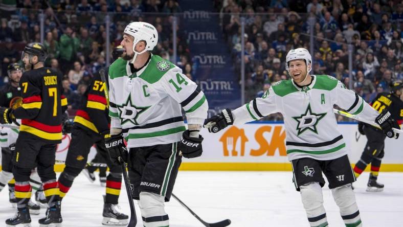 Mar 28, 2024; Vancouver, British Columbia, CAN; Dallas Stars forward Joe Pavelski (16) watches as forward Jamie Benn (14) celebrates his goal against the Vancouver Canucks in the third period at Rogers Arena. Dallas won 3 - 1. Mandatory Credit: Bob Frid-USA TODAY Sports