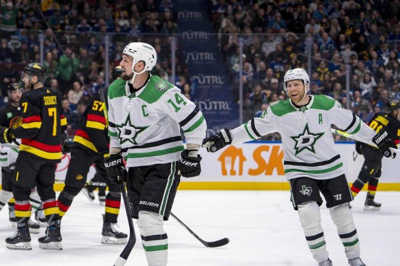 Mar 28, 2024; Vancouver, British Columbia, CAN; Dallas Stars forward Joe Pavelski (16) watches as forward Jamie Benn (14) celebrates his goal against the Vancouver Canucks in the third period at Rogers Arena. Dallas won 3 - 1. Mandatory Credit: Bob Frid-USA TODAY Sports