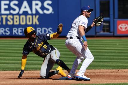 Mar 29, 2024; New York City, New York, USA; Milwaukee Brewers right fielder Jackson Chourio (11) calls for time after stealing second base behind New York Mets second baseman Jeff McNeil (1) before the game at Citi Field. Mandatory Credit: Vincent Carchietta-USA TODAY Sports
