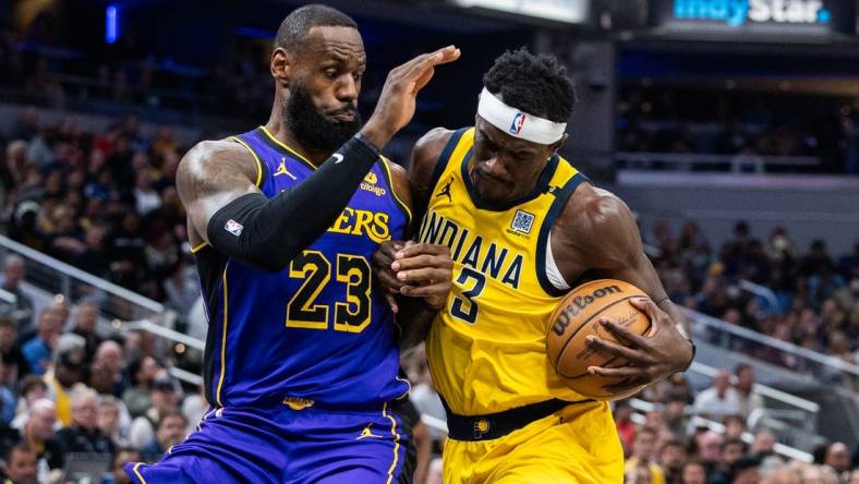 Mar 29, 2024; Indianapolis, Indiana, USA; Indiana Pacers forward Pascal Siakam (43) shoots the ball while Los Angeles Lakers forward LeBron James (23) defends in the first half at Gainbridge Fieldhouse. Mandatory Credit: Trevor Ruszkowski-USA TODAY Sports