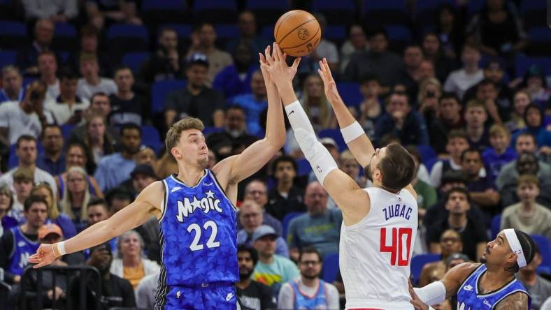 Mar 29, 2024; Orlando, Florida, USA; Orlando Magic forward Franz Wagner (22) and LA Clippers center Ivica Zubac (40) jump for the rebound during the first quarter at KIA Center. Mandatory Credit: Mike Watters-USA TODAY Sports