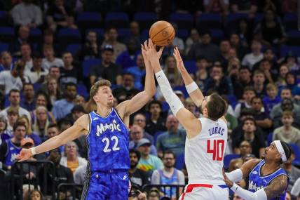 Mar 29, 2024; Orlando, Florida, USA; Orlando Magic forward Franz Wagner (22) and LA Clippers center Ivica Zubac (40) jump for the rebound during the first quarter at KIA Center. Mandatory Credit: Mike Watters-USA TODAY Sports