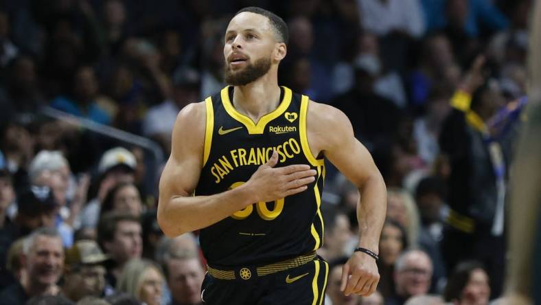 Mar 29, 2024; Charlotte, North Carolina, USA; Golden State Warriors guard Stephen Curry (30) pats his chest after making a three-point basket against the Charlotte Hornets during the first quarter at Spectrum Center. Mandatory Credit: Nell Redmond-USA TODAY Sports