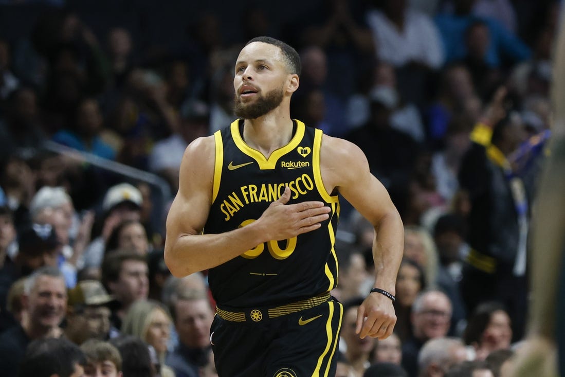 Mar 29, 2024; Charlotte, North Carolina, USA; Golden State Warriors guard Stephen Curry (30) pats his chest after making a three-point basket against the Charlotte Hornets during the first quarter at Spectrum Center. Mandatory Credit: Nell Redmond-USA TODAY Sports