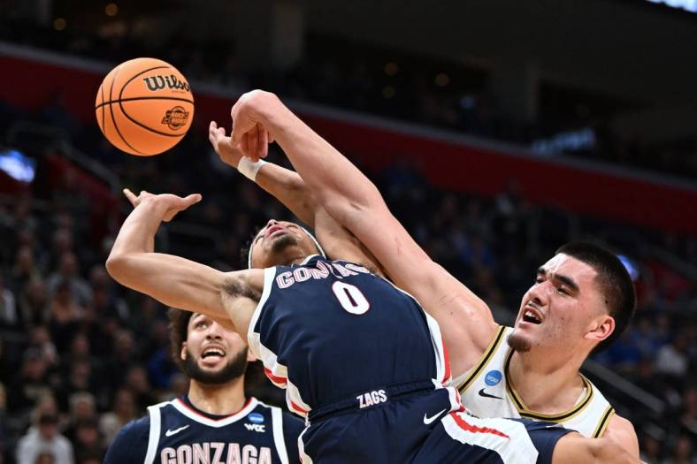 Mar 29, 2024; Detroit, MN, USA; Gonzaga Bulldogs guard Ryan Nembhard (0) battles Purdue Boilermakers center Zach Edey (15) for the ball in the first half during the NCAA Tournament Midwest Regional at Little Caesars Arena. Mandatory Credit: Lon Horwedel-USA TODAY Sports
