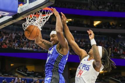 Mar 29, 2024; Orlando, Florida, USA; Orlando Magic center Wendell Carter Jr. (34) dunks in front of LA Clippers guard Terance Mann (14) during the second quarter at KIA Center. Mandatory Credit: Mike Watters-USA TODAY Sports