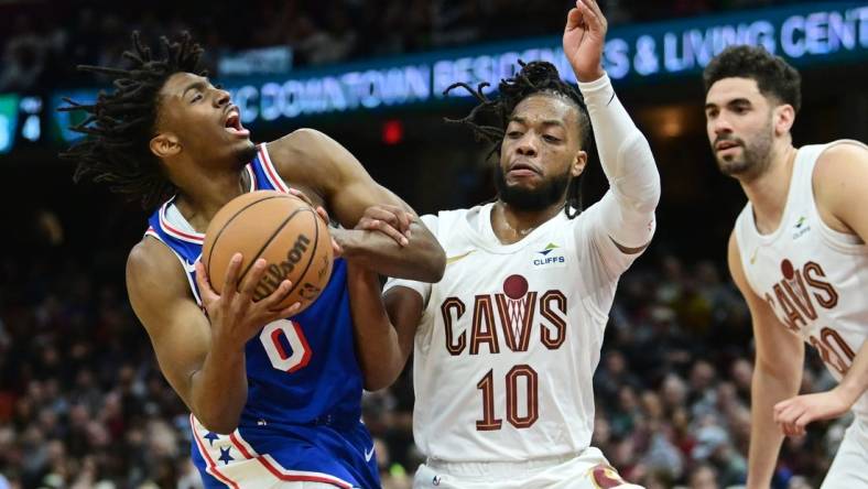 Mar 29, 2024; Cleveland, Ohio, USA; Philadelphia 76ers guard Tyrese Maxey (0) drives to the basket against Cleveland Cavaliers guard Darius Garland (10) during the first half at Rocket Mortgage FieldHouse. Mandatory Credit: Ken Blaze-USA TODAY Sports