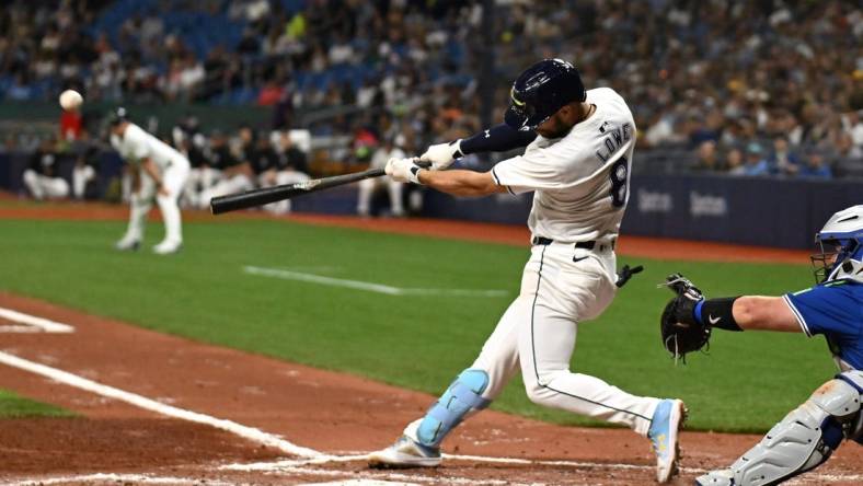 Mar 29, 2024; St. Petersburg, Florida, USA; Tampa Bay Rays second baseman Brandon Lowe (8) hits a grand slam in the third inning of the game against the Toronto Blue Jays  at Tropicana Field. Mandatory Credit: Jonathan Dyer-USA TODAY Sports