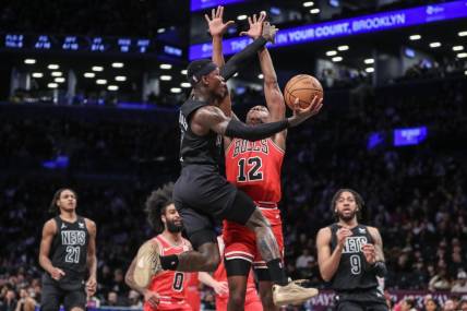 Mar 29, 2024; Brooklyn, New York, USA; Brooklyn Nets guard Dennis Schroder (17) drives past Chicago Bulls guard Ayo Dosunmu (12) in the first quarter at Barclays Center. Mandatory Credit: Wendell Cruz-USA TODAY Sports