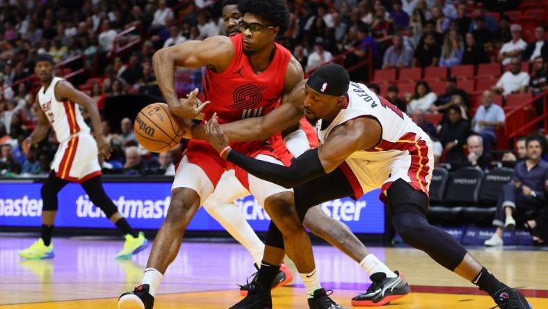 Mar 29, 2024; Miami, Florida, USA; Portland Trail Blazers guard Scoot Henderson (00) and Miami Heat center Bam Adebayo (13) battle for possession during the first quarter at Kaseya Center. Mandatory Credit: Sam Navarro-USA TODAY Sports