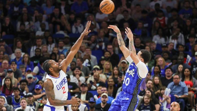 Mar 29, 2024; Orlando, Florida, USA; Orlando Magic guard Cole Anthony (50) shoots the ball over LA Clippers forward Kawhi Leonard (2) during the second half at KIA Center. Mandatory Credit: Mike Watters-USA TODAY Sports