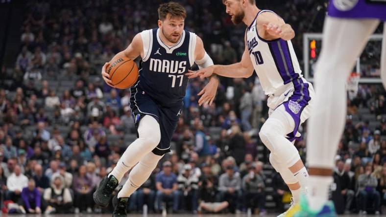 Mar 29, 2024; Sacramento, California, USA; Dallas Mavericks guard Luka Doncic (77) dribbles next to Sacramento Kings forward Domantas Sabonis (10) in the first quarter at the Golden 1 Center. Mandatory Credit: Cary Edmondson-USA TODAY Sports