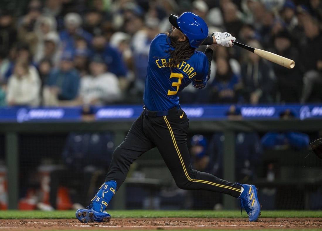 Mar 29, 2024; Seattle, Washington, USA; Seattle Mariners shortstop J.P. Crawford (3) hits a solo home run during the sixth inning against the Boston Red Sox at T-Mobile Park. Mandatory Credit: Stephen Brashear-USA TODAY Sports