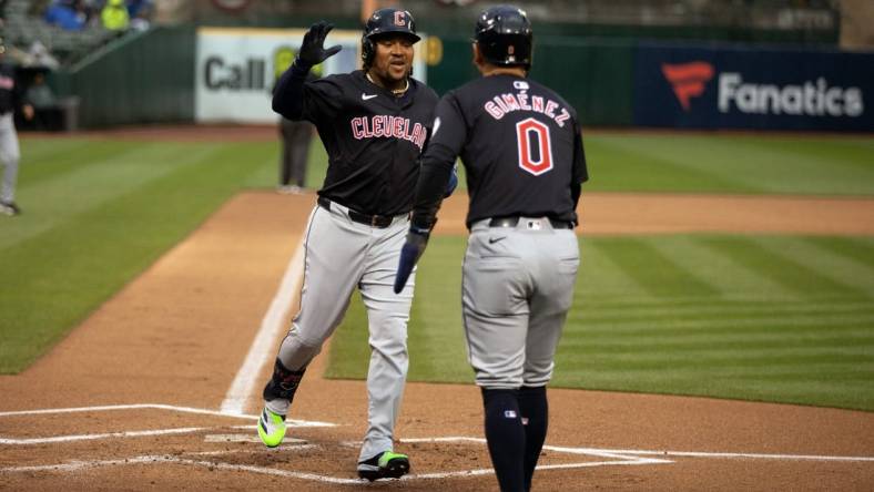 Mar 29, 2024; Oakland, California, USA; Cleveland Guardians third baseman José Ramírez (11) is greeted by teammate Andrés Giménez (0) after hitting a two-run home run against the Oakland Athletics during the first inning at Oakland-Alameda County Coliseum. Mandatory Credit: D. Ross Cameron-USA TODAY Sports