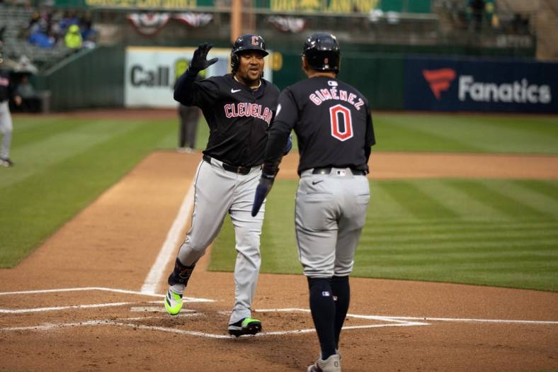 Mar 29, 2024; Oakland, California, USA; Cleveland Guardians third baseman José Ramírez (11) is greeted by teammate Andrés Giménez (0) after hitting a two-run home run against the Oakland Athletics during the first inning at Oakland-Alameda County Coliseum. Mandatory Credit: D. Ross Cameron-USA TODAY Sports