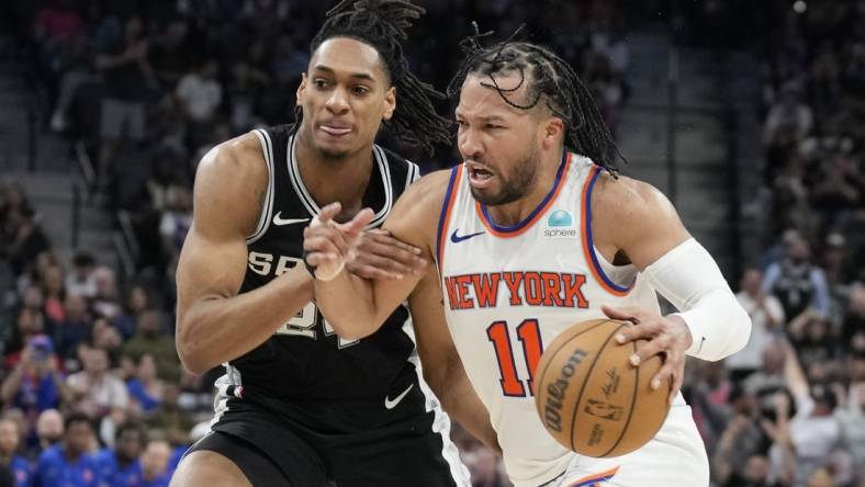 Mar 29, 2024; San Antonio, Texas, USA; New York Knicks guard Jalen Brunson (11) drives to the basket while defended by San Antonio Spurs guard Devin Vassell (24) during overtime at Frost Bank Center. Mandatory Credit: Scott Wachter-USA TODAY Sports