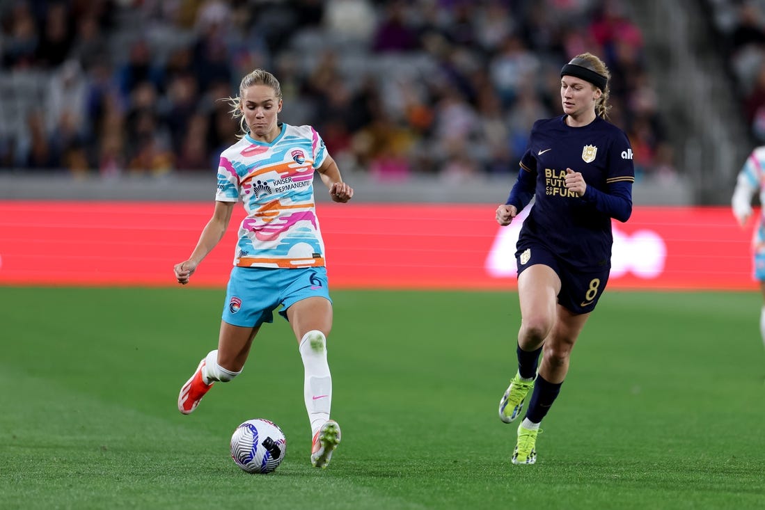 Mar 29, 2024; San Diego, California, USA; San Diego Wave FC defender Hanna Lundkvist (6) kicks the ball as Seattle Reign FC forward Bethany Balcer (8) defends during the second half at Snapdragon Stadium. Mandatory Credit: Abe Arredondo-USA TODAY Sports