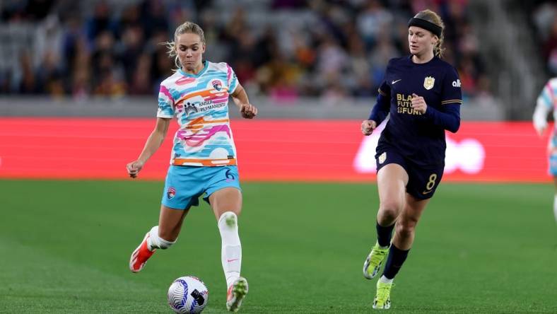 Mar 29, 2024; San Diego, California, USA; San Diego Wave FC defender Hanna Lundkvist (6) kicks the ball as Seattle Reign FC forward Bethany Balcer (8) defends during the second half at Snapdragon Stadium. Mandatory Credit: Abe Arredondo-USA TODAY Sports