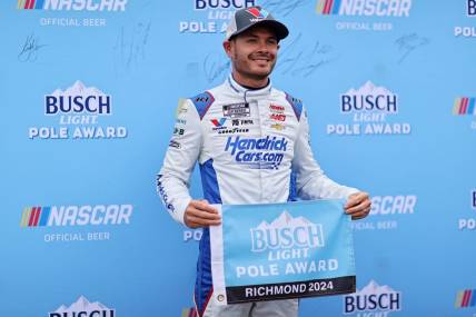 Mar 30, 2024; Richmond, Virginia, USA; NASCAR Cup Series driver Kyle Larson (5) celebrates within the pole after qualifying for the Toyota Owners 400 at Richmond Raceway. Mandatory Credit: Peter Casey-USA TODAY Sports