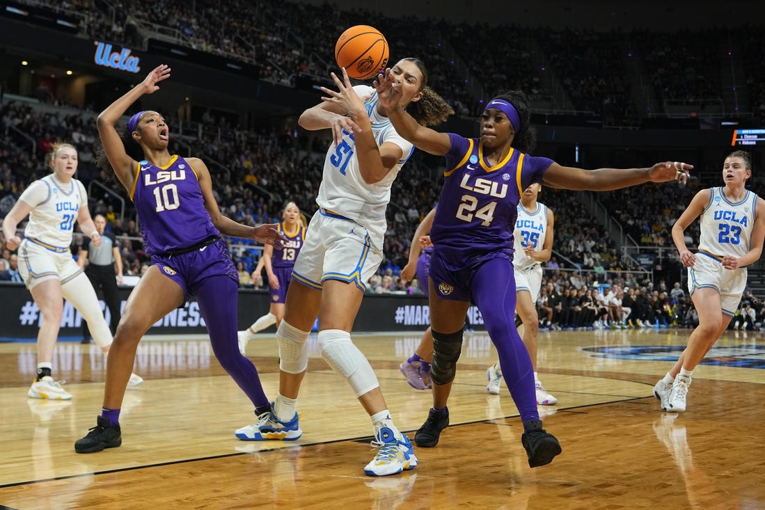 Mar 30, 2024; Albany, NY, USA; LSU Tigers guard Aneesah Morrow (24) knocks the ball away from UCLA Bruins forward Lauren Betts (51) during the first half in the semifinals of the Albany Regional of the 2024 NCAA Tournament at MVP Arena. Mandatory Credit: Gregory Fisher-USA TODAY Sports