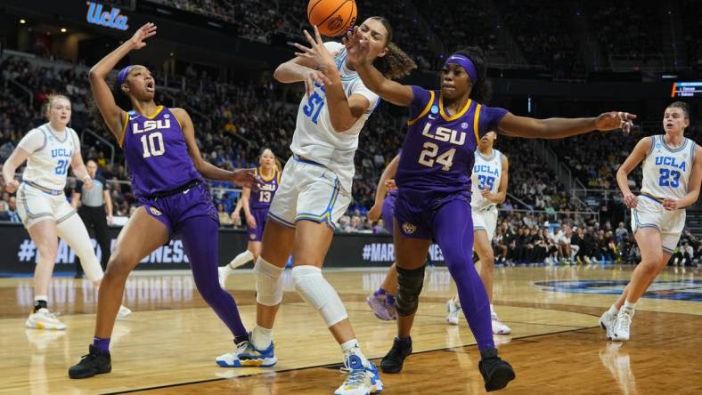 Mar 30, 2024; Albany, NY, USA; LSU Tigers guard Aneesah Morrow (24) knocks the ball away from UCLA Bruins forward Lauren Betts (51) during the first half in the semifinals of the Albany Regional of the 2024 NCAA Tournament at MVP Arena. Mandatory Credit: Gregory Fisher-USA TODAY Sports