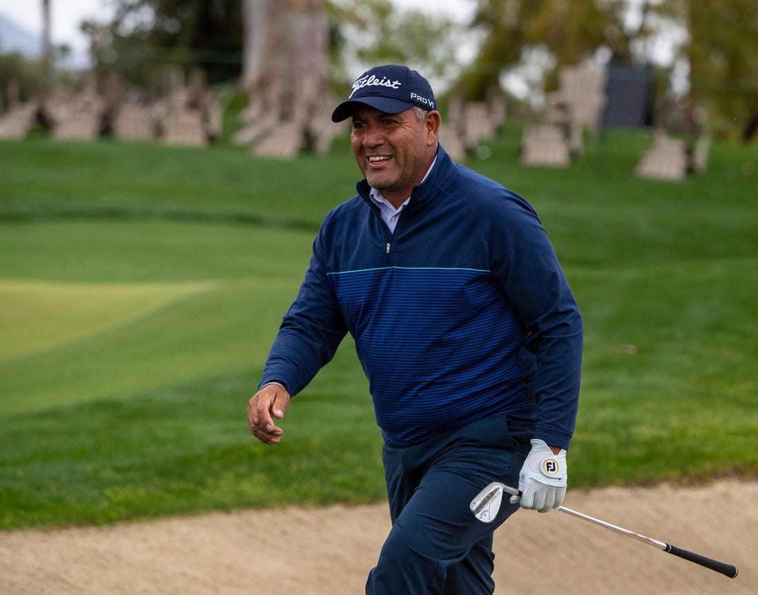 Ricardo Gonzalez smiles at his caddie and son, Santiago, after hitting out of a bunker and onto the green on 17 during the second round of The Galleri Classic at Mission Hills Country Club in Rancho Mirage, Calif., Saturday, March 30, 2024.