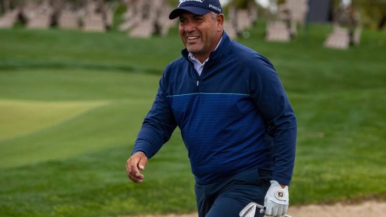 Ricardo Gonzalez smiles at his caddie and son, Santiago, after hitting out of a bunker and onto the green on 17 during the second round of The Galleri Classic at Mission Hills Country Club in Rancho Mirage, Calif., Saturday, March 30, 2024.