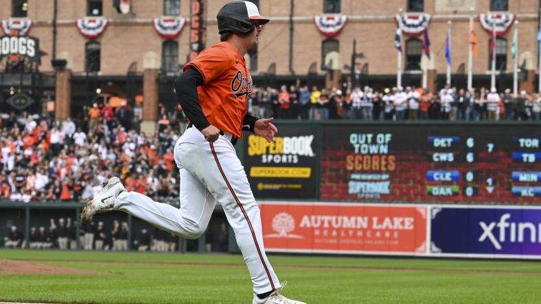 Mar 30, 2024; Baltimore, Maryland, USA;  Baltimore Orioles catcher Adley Rutschman (35) scores on  first baseman Ryan Mountcastle (not pictured) first inning double against the Los Angeles Angels at Oriole Park at Camden Yards. Mandatory Credit: Tommy Gilligan-USA TODAY Sports