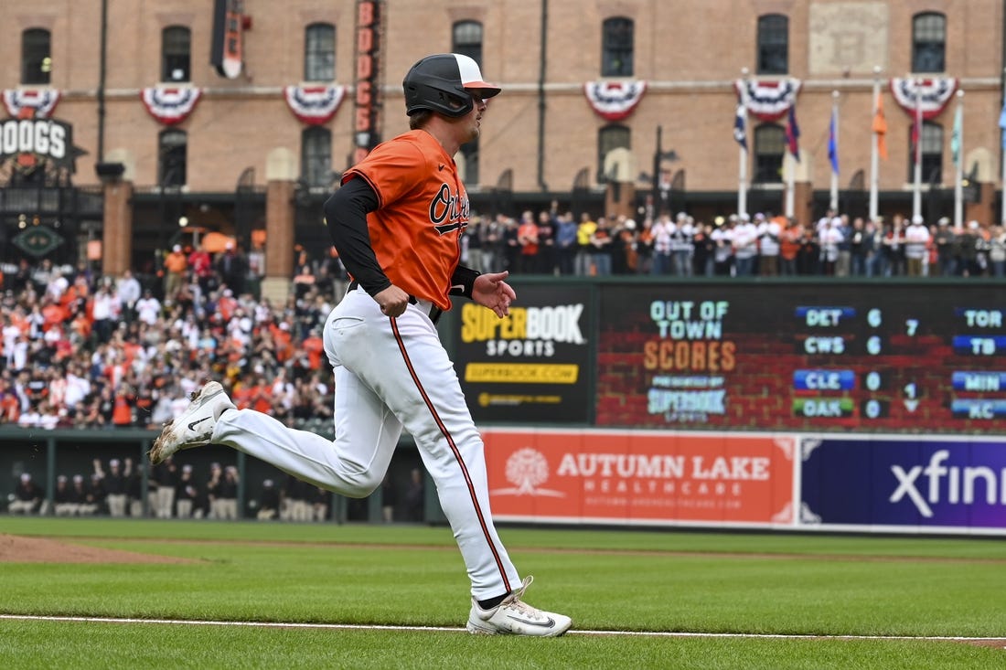 Mar 30, 2024; Baltimore, Maryland, USA;  Baltimore Orioles catcher Adley Rutschman (35) scores on  first baseman Ryan Mountcastle (not pictured) first inning double against the Los Angeles Angels at Oriole Park at Camden Yards. Mandatory Credit: Tommy Gilligan-USA TODAY Sports