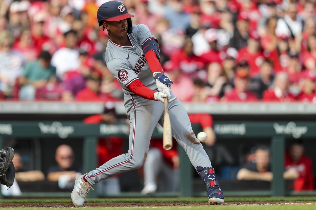 Mar 30, 2024; Cincinnati, Ohio, USA; Washington Nationals third baseman Trey Lipscomb (38) hits a single against the Cincinnati Reds in the third inning at Great American Ball Park. Mandatory Credit: Katie Stratman-USA TODAY Sports