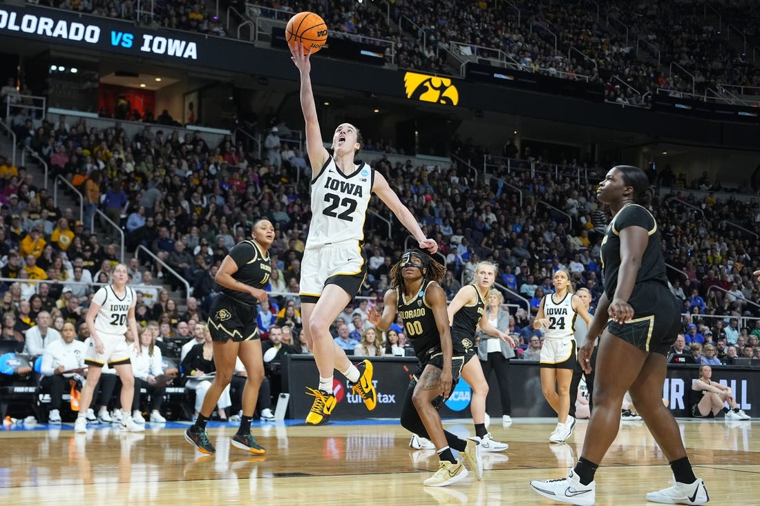 Mar 30, 2024; Albany, NY, USA;  Iowa Hawkeyes guard Caitlin Clark (22) shoots the ball past Colorado Buffaloes guard Jaylyn Sherrod (0) during the second half in the semifinals of the Albany Regional of the 2024 NCAA Tournament at MVP Arena. Mandatory Credit: Gregory Fisher-USA TODAY Sports
