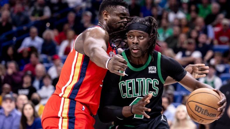 Mar 30, 2024; New Orleans, Louisiana, USA;  Boston Celtics guard Jrue Holiday (4) dribbles against New Orleans Pelicans forward Zion Williamson (1) during the first half at Smoothie King Center. Mandatory Credit: Stephen Lew-USA TODAY Sports