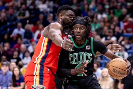 Mar 30, 2024; New Orleans, Louisiana, USA;  Boston Celtics guard Jrue Holiday (4) dribbles against New Orleans Pelicans forward Zion Williamson (1) during the first half at Smoothie King Center. Mandatory Credit: Stephen Lew-USA TODAY Sports