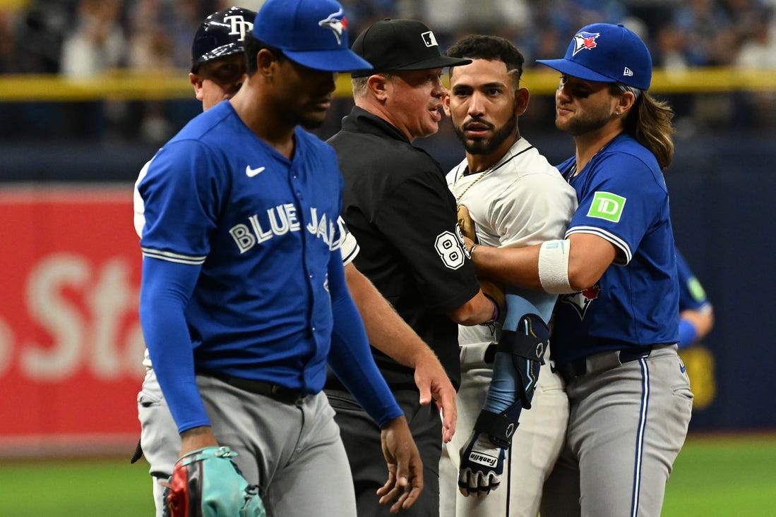Mar 30, 2024; St. Petersburg, Florida, USA; Tampa Bay Rays shortstop Jose Caballero (7) stares at Toronto Blue Jays relief pitcher Genesis Cabrera (92) after they collide in the seventh inning of the game  at Tropicana Field. Mandatory Credit: Jonathan Dyer-USA TODAY Sports